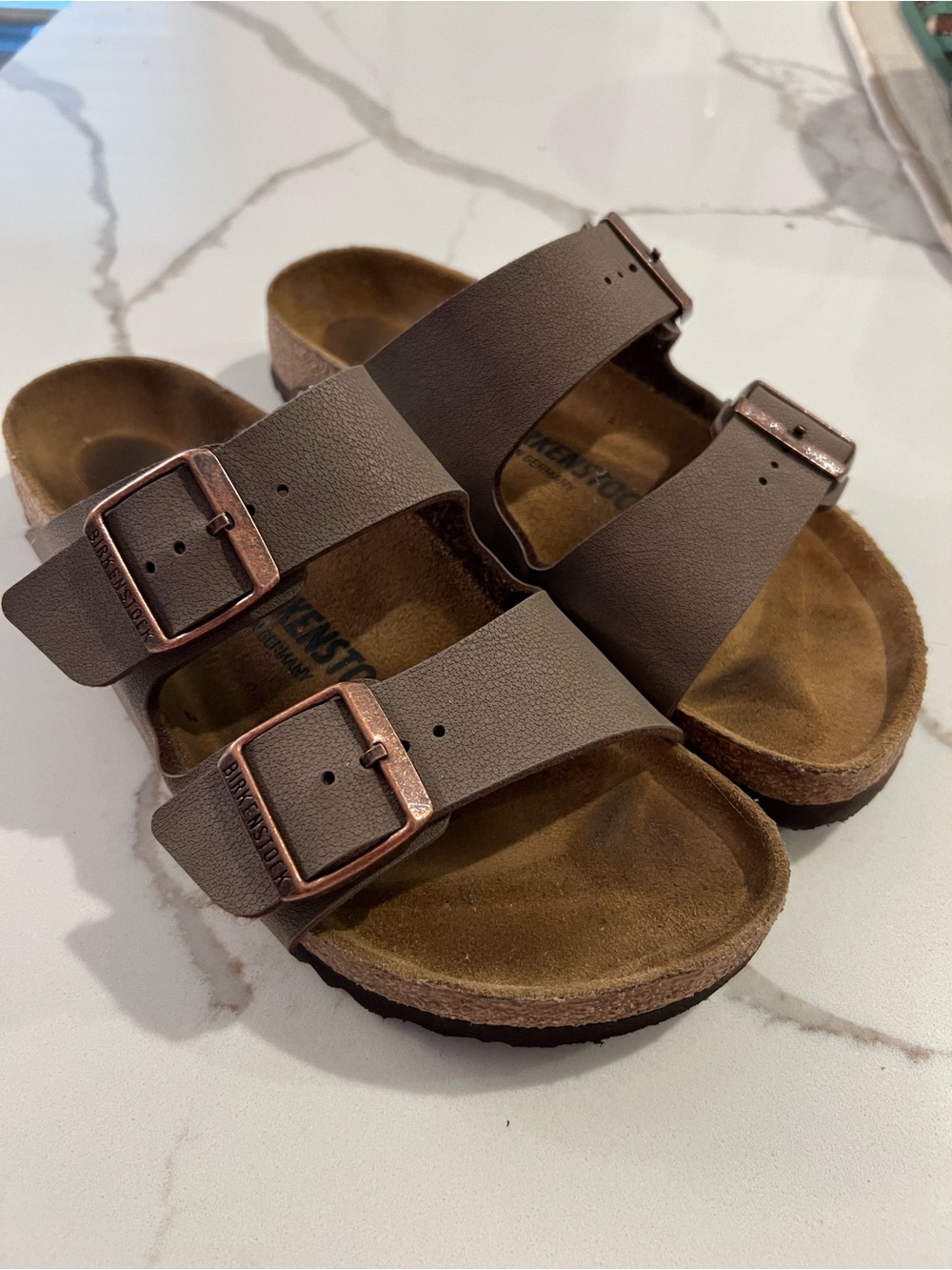 Birkenstock Arizona Two-Strap Sandals in Dark Brown with Copper Buckles